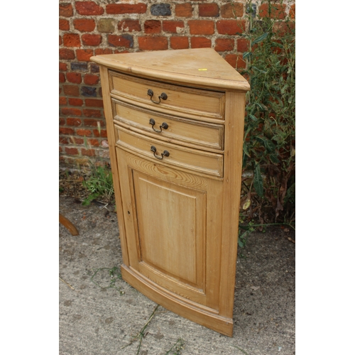 615 - A pine bowfront cupboard, fitted three drawers over panel door, 23