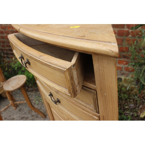 615 - A pine bowfront cupboard, fitted three drawers over panel door, 23