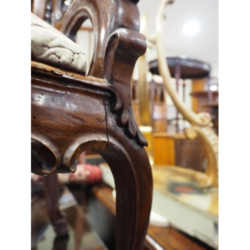 435 - A 19th century carved walnut nursing chair with shaped splat and drop-in seat, upholstered in floral... 