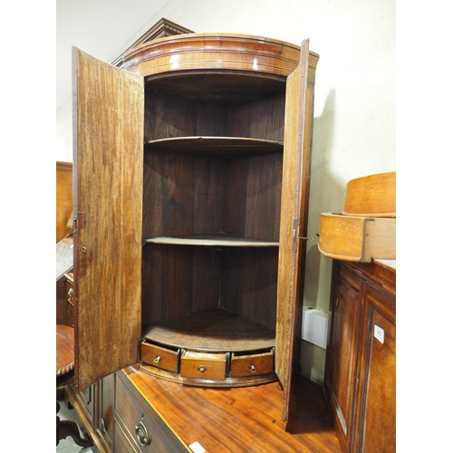 439 - A late Georgian provincial oak and inlaid bowfront corner cupboard, enclosed two doors with strap, 2... 