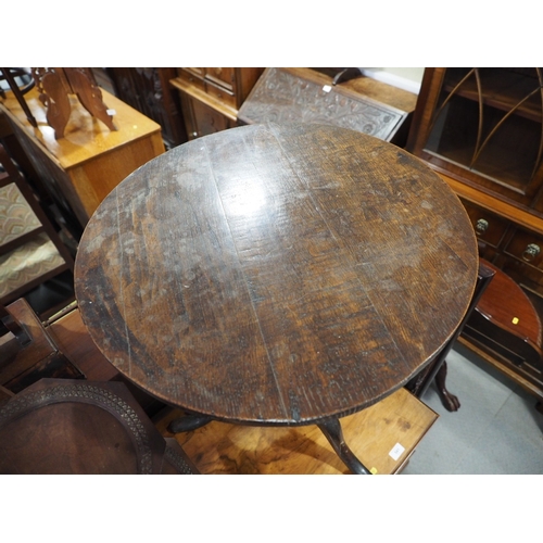 440 - An 18th century provincial oak circular tilt top occasional table, on turned column and tripod splay... 