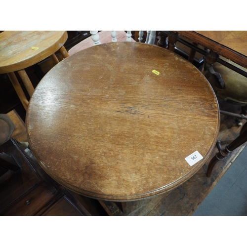 567 - A walnut circular top two-tier occasional table, 22