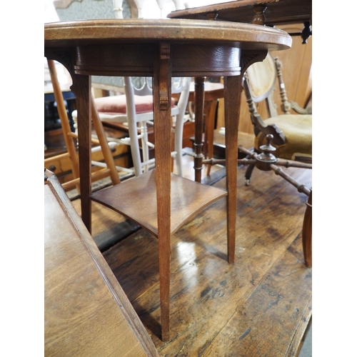 567 - A walnut circular top two-tier occasional table, 22