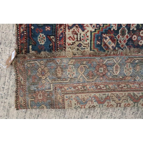 632 - A Qashqai type rug with three medallions on a bird and flower figured white ground