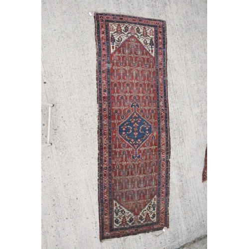 633 - A Caucasian runner with all-over geometric design on a rust ground and blue central medallion