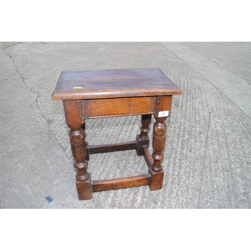 587 - An oak joint stool of 16th century design with carved turned supports united by stretcher rails, 17