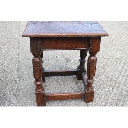 587 - An oak joint stool of 16th century design with carved turned supports united by stretcher rails, 17