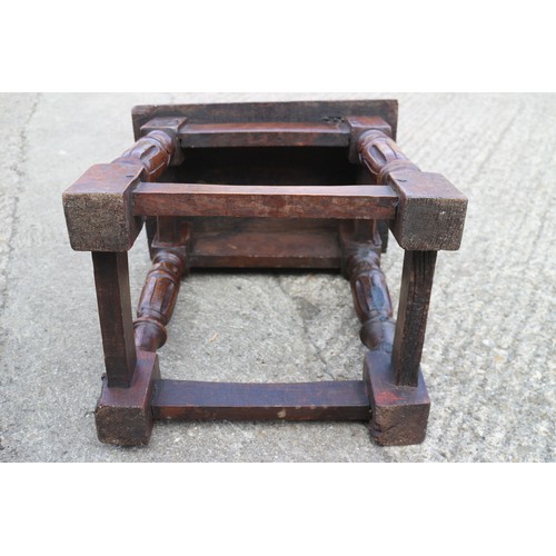 587 - An oak joint stool of 16th century design with carved turned supports united by stretcher rails, 17