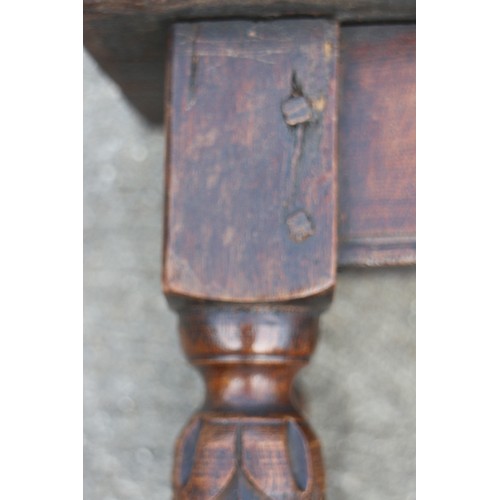 587 - An oak joint stool of 16th century design with carved turned supports united by stretcher rails, 17