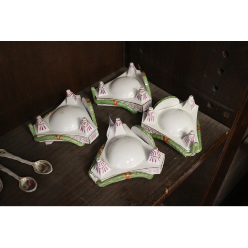 9 - A set of four Continental porcelain table salts with swag and painted plaque decoration on three tap... 