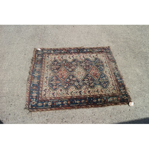 632 - A Qashqai type rug with three medallions on a bird and flower figured white ground