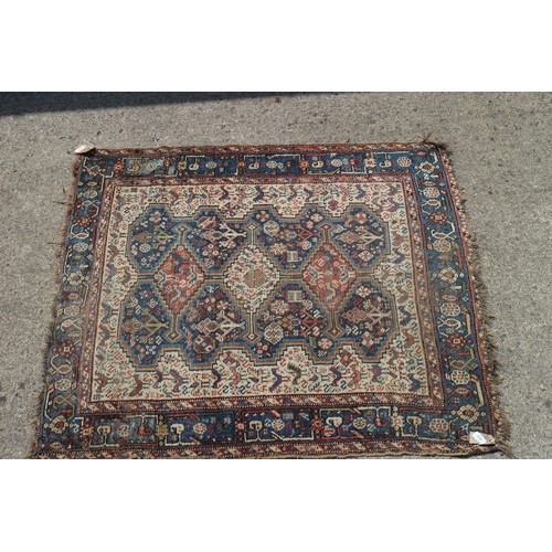 632 - A Qashqai type rug with three medallions on a bird and flower figured white ground