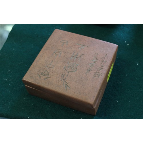 61 - A Chinese terracotta square-shaped box and cover with character decoration and seal mark to base, 3 ... 