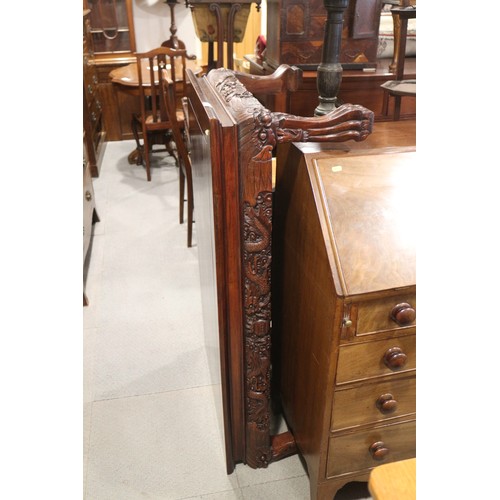 568 - A Chinese carved hardwood low table with dragon masks and paw feet, 47