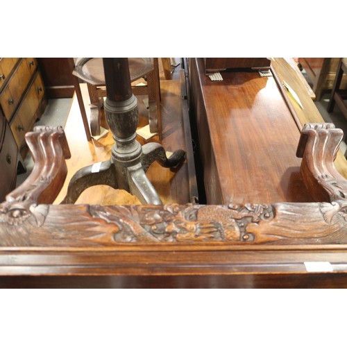 568 - A Chinese carved hardwood low table with dragon masks and paw feet, 47