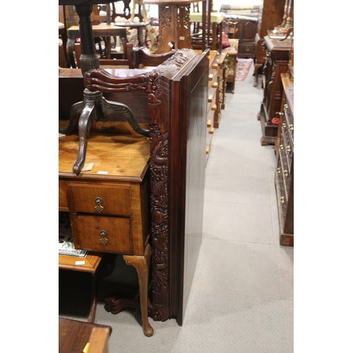 568 - A Chinese carved hardwood low table with dragon masks and paw feet, 47