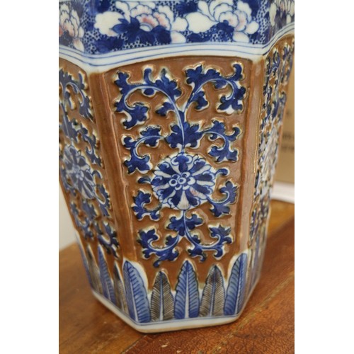 66 - A Chinese blue and white relief decorated hexagonal vase with cafe-au-lait ground, 13 1/2