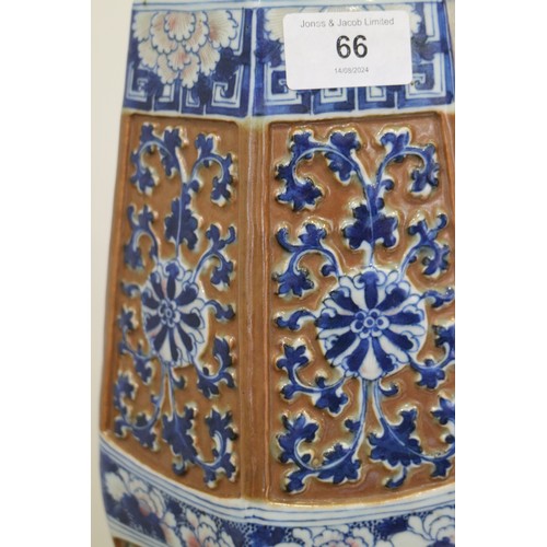 66 - A Chinese blue and white relief decorated hexagonal vase with cafe-au-lait ground, 13 1/2