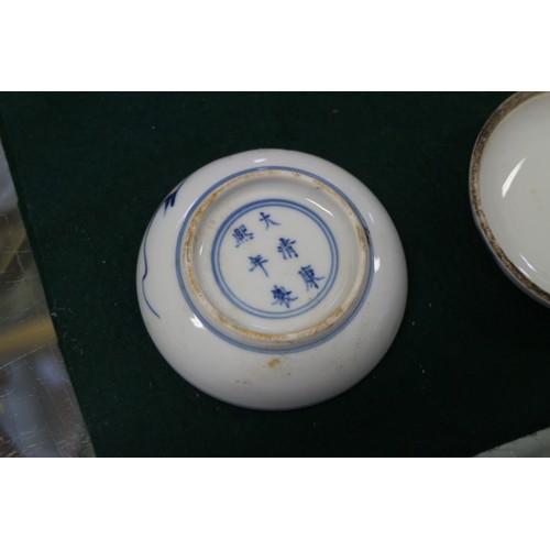 60 - A Chinese blue and white dish with dragon and cloud decoration, seal mark to base, 4” dia, a blue an... 