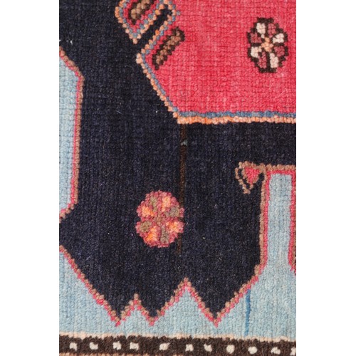 674 - A Caucasian rug with three red medallions on a black ground, and bird and floral border on a light b... 