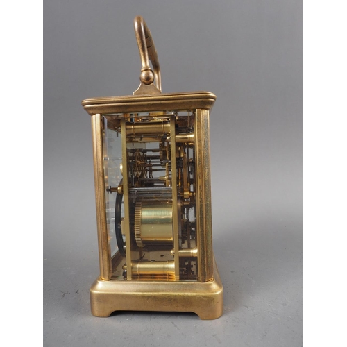 100 - A brass cased carriage clock with white enamel dial and repeater alarm movement, 5 1/2