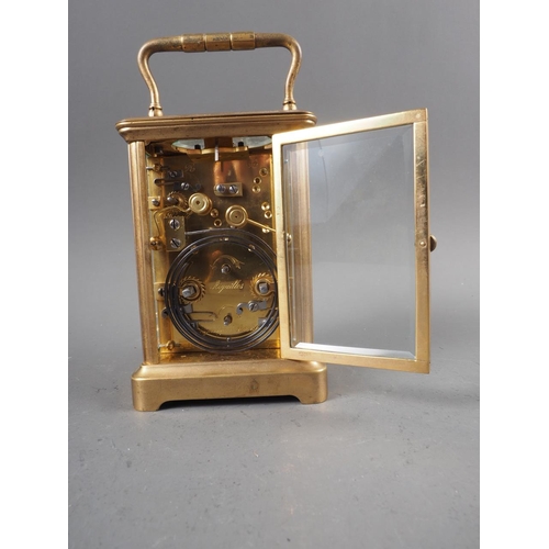 100 - A brass cased carriage clock with white enamel dial and repeater alarm movement, 5 1/2