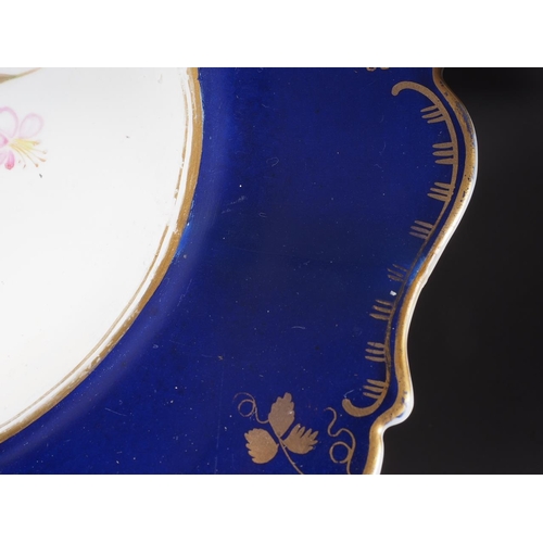 23 - A Coalport style dessert service with floral decoration on a blue and gilt ground