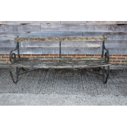 682 - A wrought iron slatted garden bench, on scroll end supports, 72