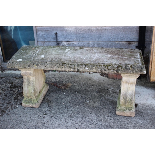 684 - A cast stone garden bench, on scroll panel end supports, 46