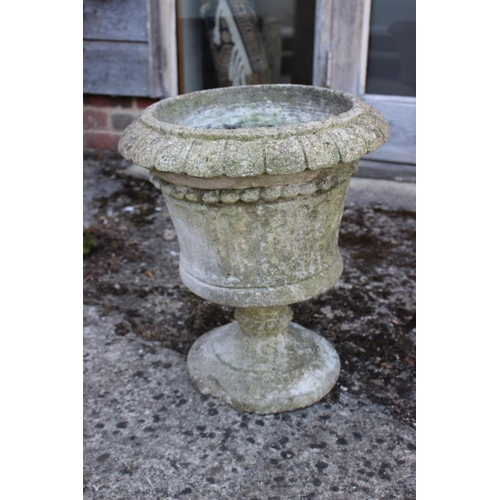 686 - A cast stone campana planter, 18