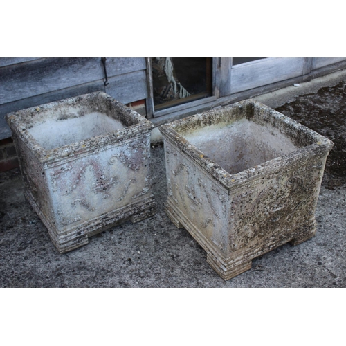 687 - A pair of cast stone square planters with vase and swag decoration, 19