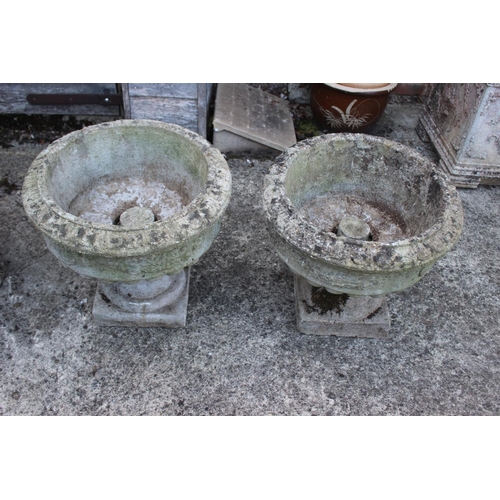 688 - A pair of cast stone two-piece planters, on square bases, 18