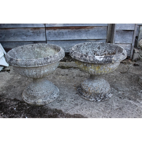 689 - A pair of cast stone and single-piece fluted planters, on square bases, 16