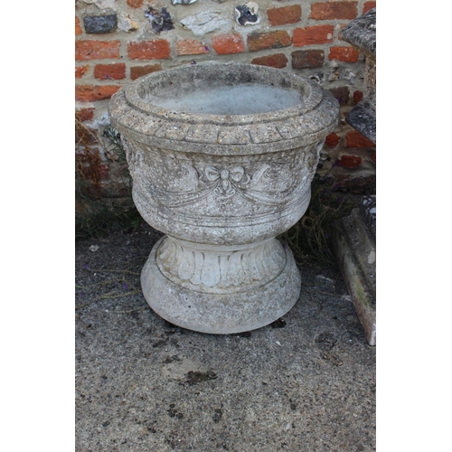 691 - A cast stone two-piece circular planter with swag decoration, on circular bases, 24