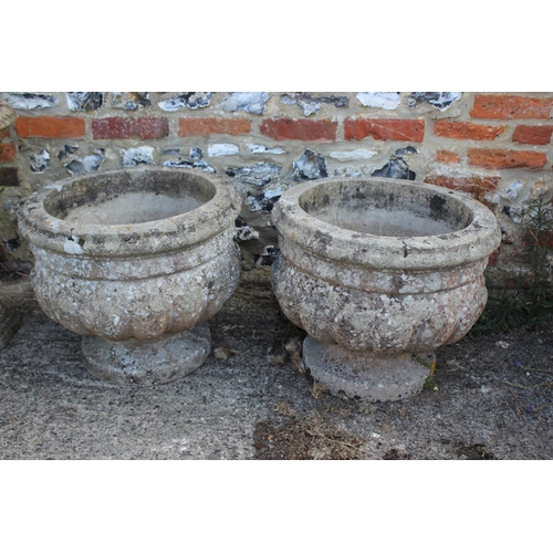 692 - A pair of cast stone lobed planters, on circular bases, 16