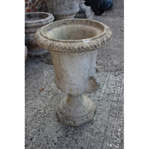 693 - A cast stone two-handle campana planter, on octagonal base, 24