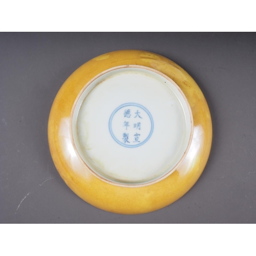 72 - A Chinese yellow glazed shallow dish with six-character mark to base, 7