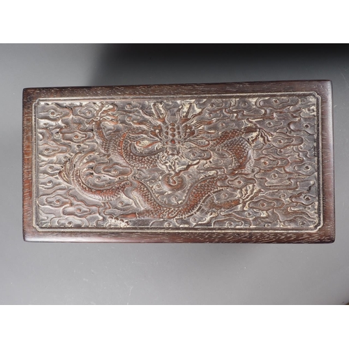 91 - A Chinese zitan hinged box with carved dragon decoration, 13 1/2