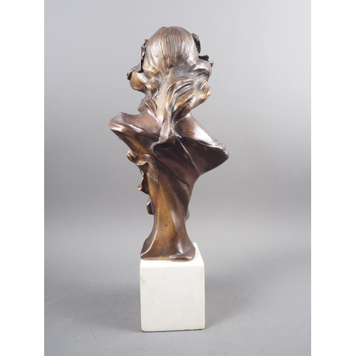 116 - A patinated brass bust of an Art Nouveau style woman, on a square marble block base, 16 1/4