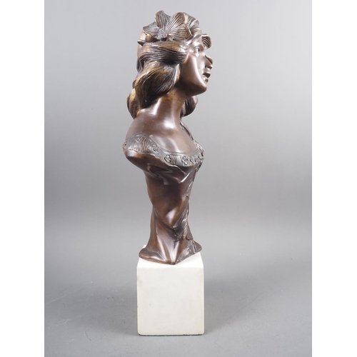 116 - A patinated brass bust of an Art Nouveau style woman, on a square marble block base, 16 1/4