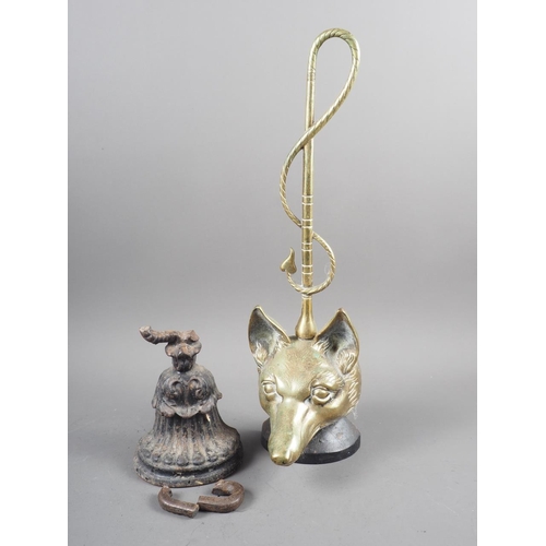 131 - A brass and cast iron fox mask door stop and a cast iron door stop (damages)