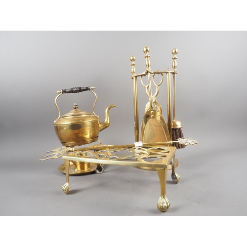 135 - A 19th century brass footman, on claw and ball feet, a brass kettle, on stand with burner, a toastin... 