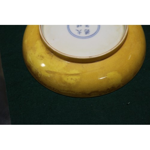 72 - A Chinese yellow glazed shallow dish with six-character mark to base, 7