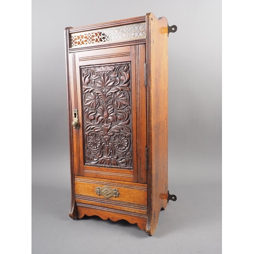 178 - A smoker's Edwardian carved mahogany cabinet with gallery top, fitted interior and one drawer, 8 1/4... 