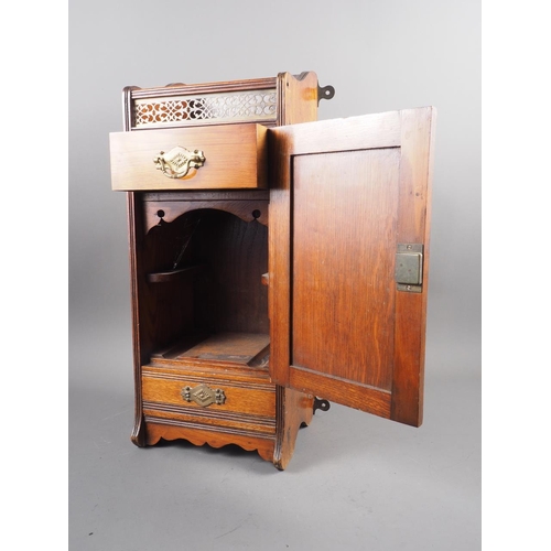 178 - A smoker's Edwardian carved mahogany cabinet with gallery top, fitted interior and one drawer, 8 1/4... 