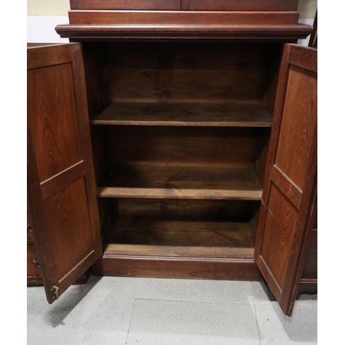 394 - A 19th century mahogany bookcase with broken pediment over two glazed doors and two panelled doors, ... 