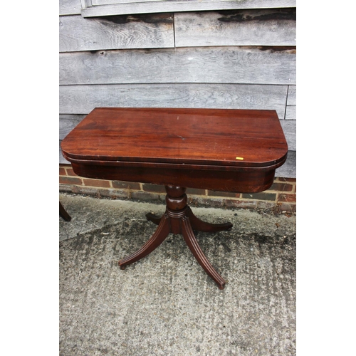 429 - A 19th century mahogany fold-over top tea table, on turned column and quadruple splay support, 36