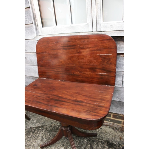 429 - A 19th century mahogany fold-over top tea table, on turned column and quadruple splay support, 36