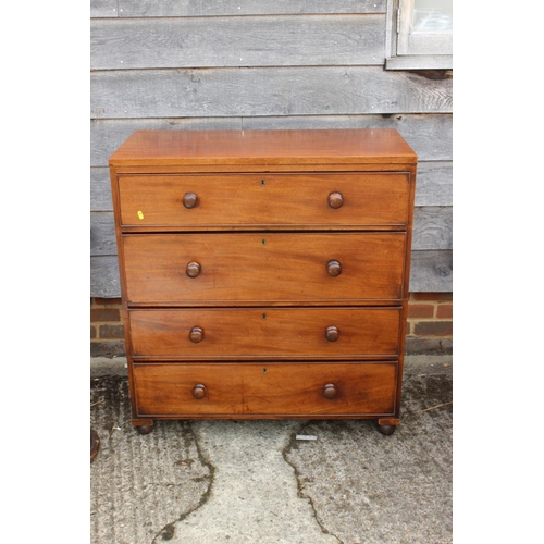 446 - An early 19th century mahogany campaign chest of four long graduated drawers with knob handles, on b... 