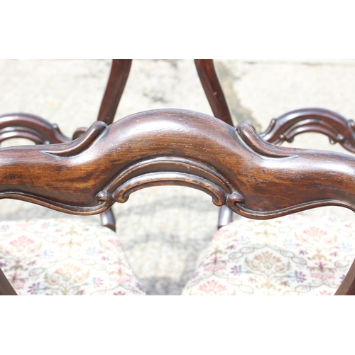 448 - A set of five mid 19th century rosewood bar back dining chairs with stuffed over seats, on turned su... 